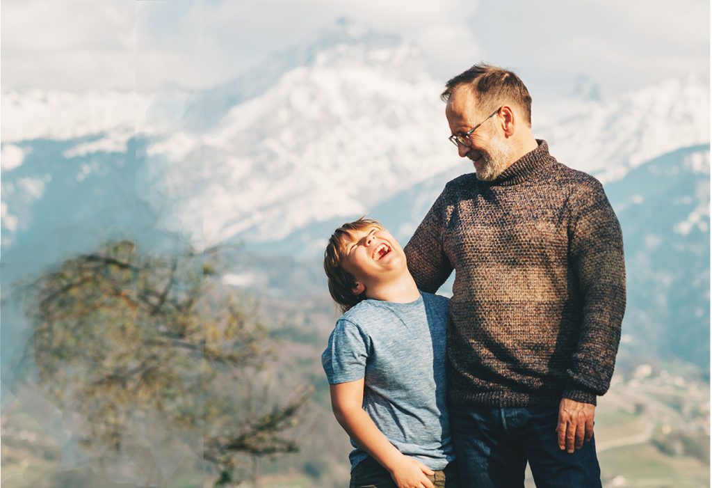 Happy laughing father and son hiking